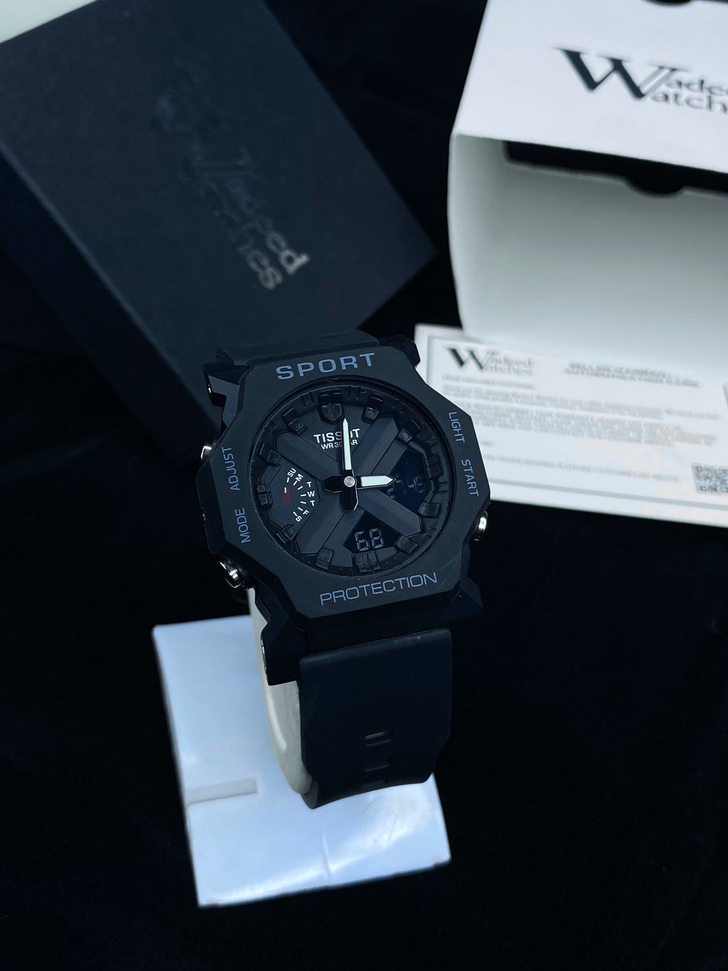 Black sports watch with digital display on a dark background